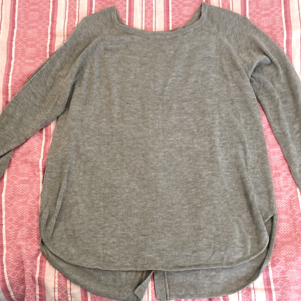 Light sweater with buttons down back. No defects . Like new.